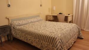 a bedroom with a bed with a table and a desk at Castellu in Lucciana