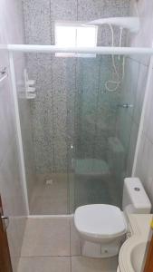 a bathroom with a shower with a toilet and a sink at Recanto do Dan - Praia Picarras- Beto Carrero in Piçarras