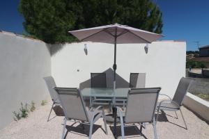 a table and chairs with an umbrella on a patio at Maison indépendante in Marseille