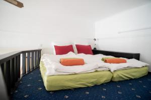 ブダペストにあるPalace Trees Apartmentのベッド(白いシーツ、赤い枕付)