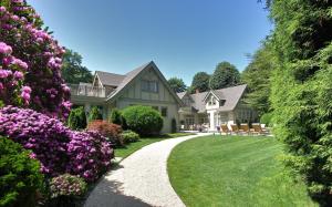 a house with pink flowers in the yard at The Baker House 1650 in East Hampton