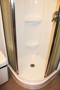 a shower stall with a toilet in a bathroom at Auberge L'Apero in Montreal