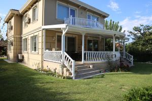 a house with a large porch with a large deck at Damla Pansiyon in Sapanca