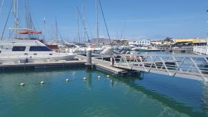 a group of boats docked at a marina at Marina Lucky in Playa Blanca