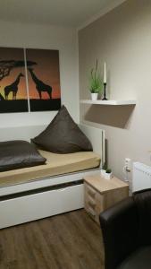a bedroom with a bed with a picture of a giraffe at FeWo Wilhelmshaven Voslapp 267 in Wilhelmshaven