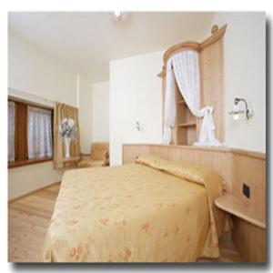 a bedroom with a large bed and a sink at Locanda Borgo Chiese in Condino
