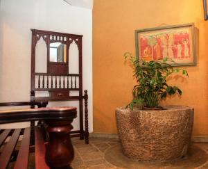 a plant in a pot in a room with a mirror at Gruhaya Boutique Villa in Kandy