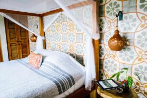 a bedroom with a bed and a table with a tablet at Isleta El Espino in Isletas de Granada