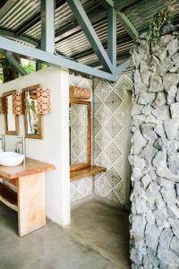 a bathroom with a sink and a stone wall at Isleta El Espino in Isletas de Granada