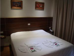 Ένα ή περισσότερα κρεβάτια σε δωμάτιο στο Pissoloto Hotel