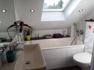 a bathroom with a sink and a bath tub at Bella Casa & Belle Maison in Saarbrücken +44 photos