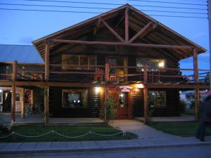 a large wooden house with a large roof at Calafate Hostel in El Calafate