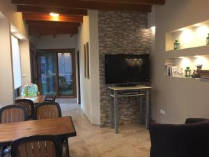 a living room with a television and a table with chairs at Vaya Apartments & Studios in Platamonas