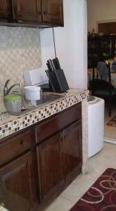 a kitchen with a counter top with a refrigerator at Robby's Place in Harbour View