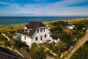 an aerial view of a house with the ocean at Haus Windhook in Dierhagen