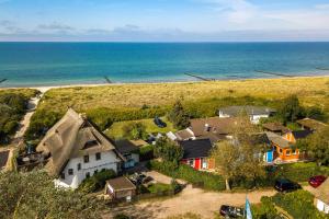 an aerial view of a house near the ocean at Haus Windhook in Dierhagen