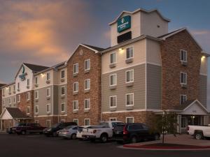 a hotel with cars parked in a parking lot at Extended Stay America Select Suites - Salt Lake City - West Valley City in West Valley City