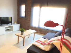 a living room with a couch and a table at Suites La Catedral in León