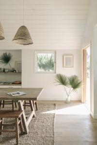 a dining room with a wooden table and a rug at The Surfrider Malibu in Malibu