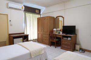 Postel nebo postele na pokoji v ubytování Phawana Sweet Hotel