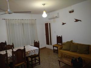 a living room with a couch and a table at Departamentos Chiquina in Las Grutas