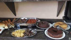 a bunch of different types of food on a counter at Hotel Juruá in Cruzeiro do Sul