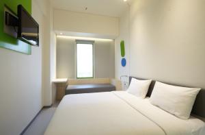Postel nebo postele na pokoji v ubytování POP! Hotel Festival Citylink