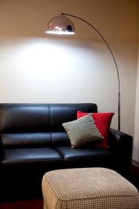 a living room with a couch and a lamp at Cattlemans Country Motor Inn & Serviced Apartments in Dubbo