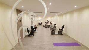 a fitness room with a row of exercise bikes at Hotelpark der Westerwald Treff in Oberlahr