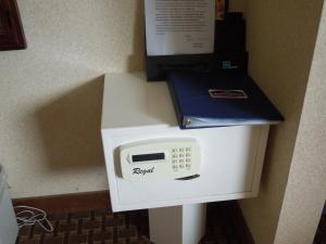 a white microwave with a box on top of it at Howard Johnson by Wyndham Virginia Beach in Virginia Beach