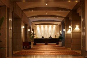 a view of a lobby with two people in the background at The Residential Suites Fukuoka in Fukuoka