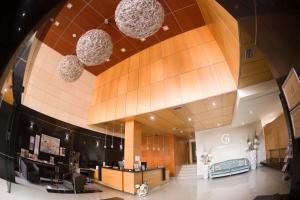 a lobby of a store with chandeliers at Sercotel Gran Fama in Almería