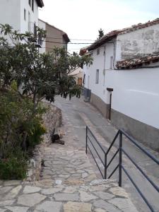 an empty street next to a white building at Pati Curreu in Palanques
