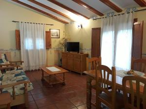 a living room with a bed and a tv at Pati Curreu in Palanques