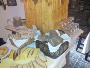 een tafel met veel verschillende soorten brood bij Casa do Terreiro in Pardieiros