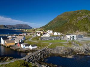 une petite ville sur la rive d'une masse d'eau dans l'établissement Runde Miljøsenter & Opplev Runde, à Runde