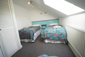 En eller flere senge i et værelse på Bwthyn Glyn