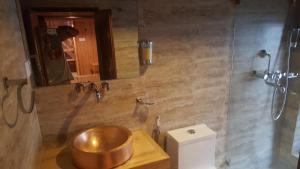 a bathroom with a copper sink and a toilet at Boutique Heritage Home in Pātan +95 photos
