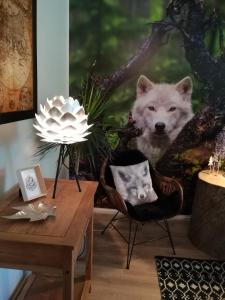 a room with a table with two chairs and a wolf picture at Arctic Home in Rovaniemi