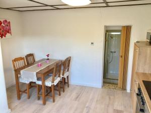 a dining room table and chairs in a room at Haus auf der alten Düne 2 in Prerow