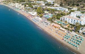 an aerial view of a beach with umbrellas and chairs at Hotel Parco Smeraldo Terme in Ischia