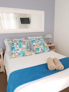 a bedroom with a bed with towels on it at Point Village Accommodation - Santos 7 in Mossel Bay