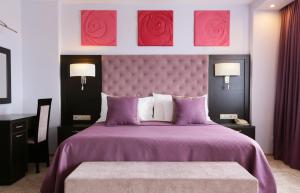 Dormitorio con cama morada con rosas en la pared en Izmailovo Alfa Hotel, en Moscú