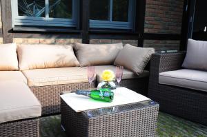 a couch and a table with a flower on it at Aaltine 3 in Bad Bentheim