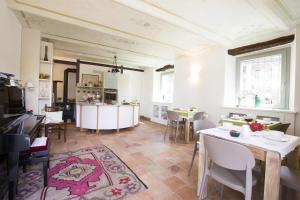 a kitchen and dining room with tables and chairs at Carossi B&B in Castagnole Lanze