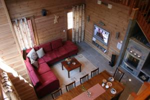 ブオカッティにあるVuokatin Aateli Villa Ruhtinatarのリビングルーム(赤いソファ、テーブル付)