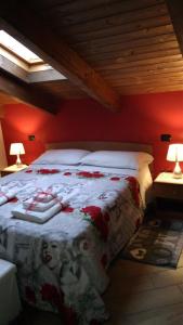 a bedroom with a large bed with red walls at Casa Delle Rose in Capaccio-Paestum
