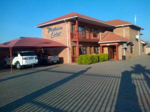 un edificio con un'auto parcheggiata di fronte di Platinum Lodge Polokwane a Polokwane