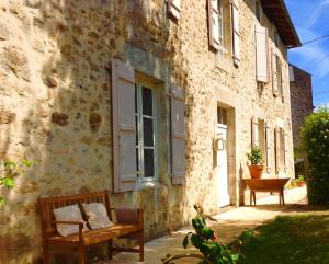 a bench sitting outside of a building with a window at Domaine Charente - Holiday Home with own garden in Mazières