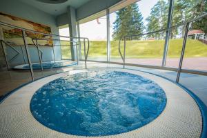 two hot tubs in a room with windows at Royal SPA Residence in Birštonas